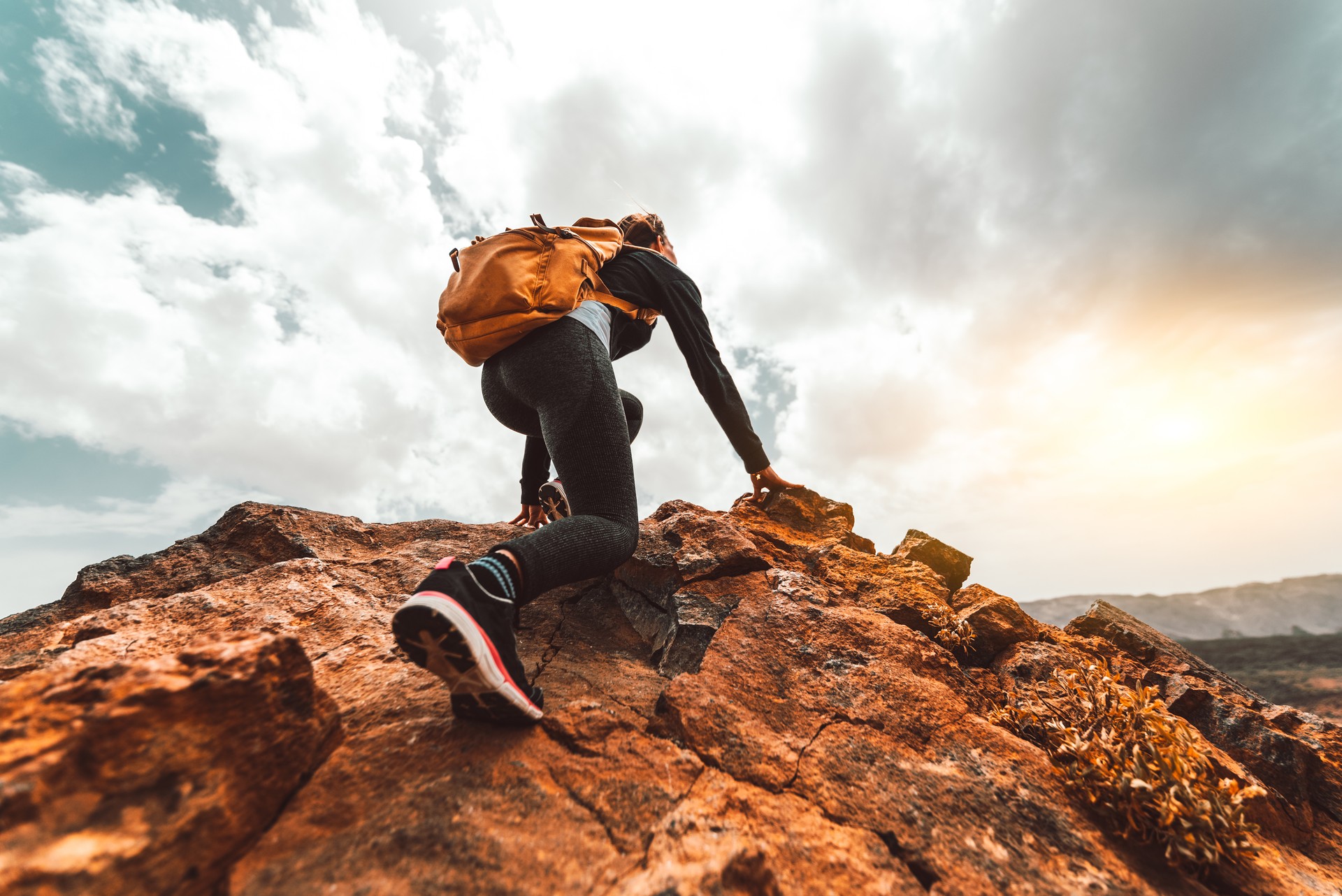 Success woman hiker hiking on sunrise mountain peak - Young woman with backpack rise to the mountain top. Discovery Travel Destination Concept