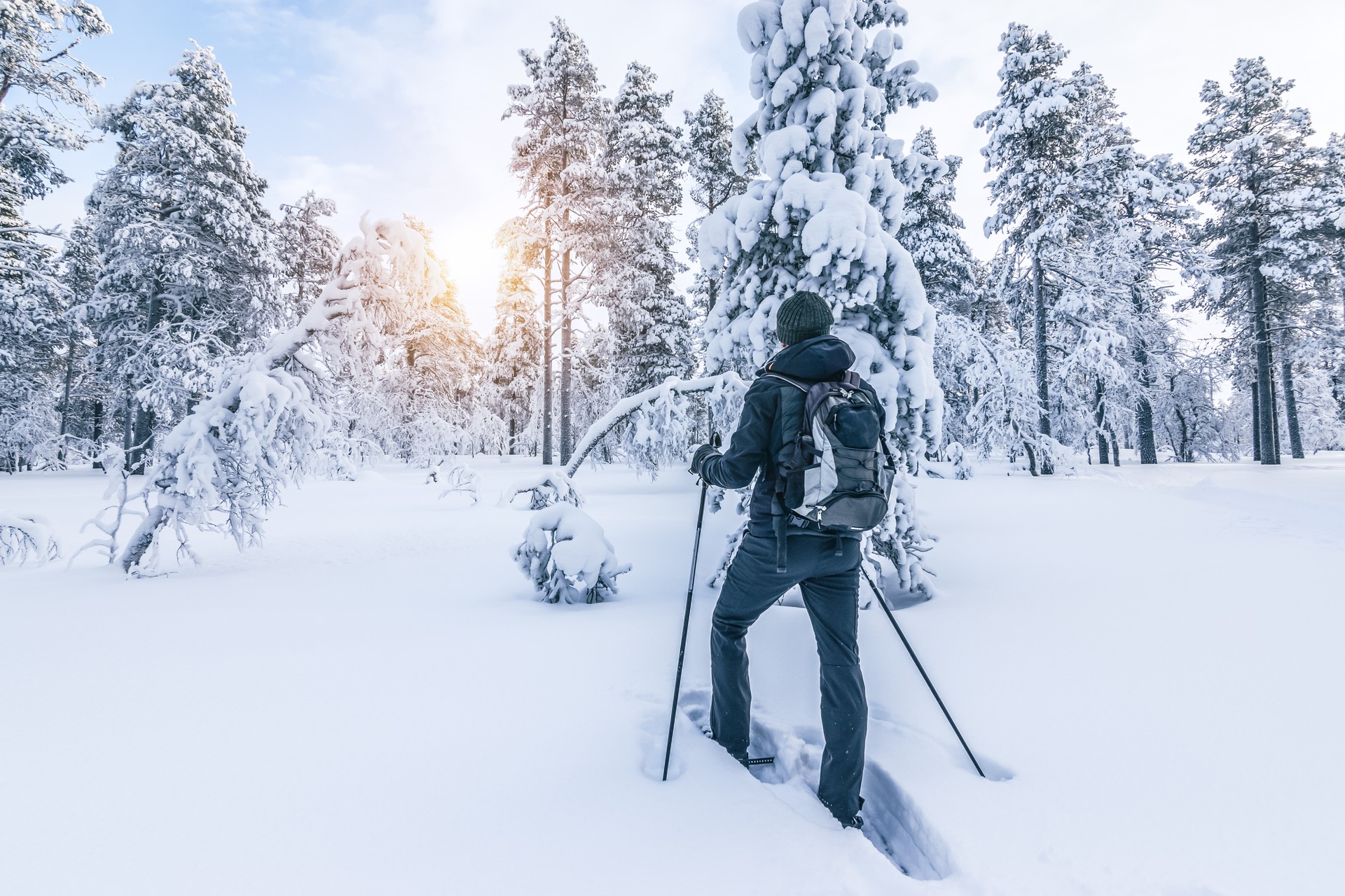 Snowshoe hiker walking in the snow. Outdoor winter sport activity and healthy lifestyle concept.