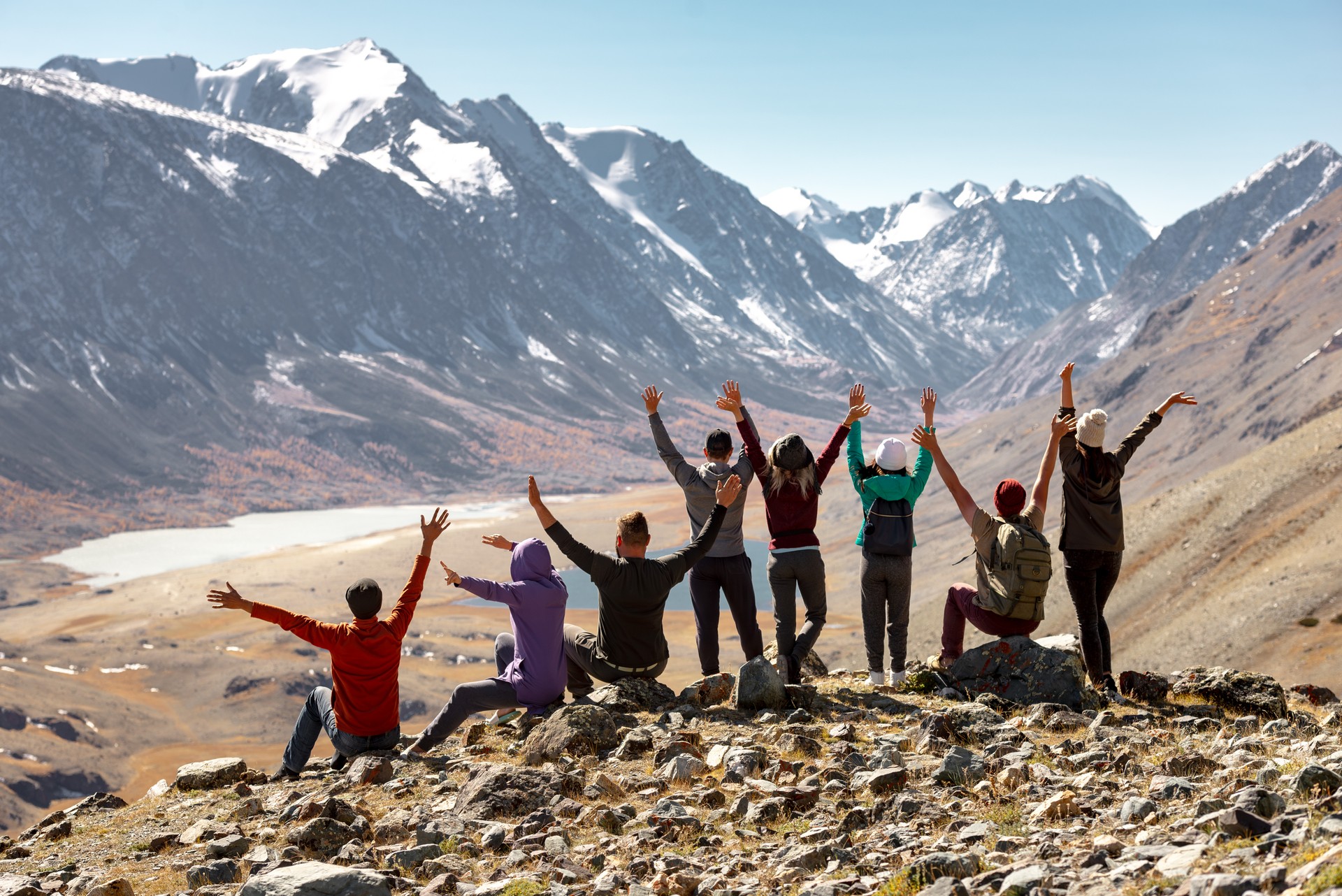 Big group of happy friends or tourists in mountains